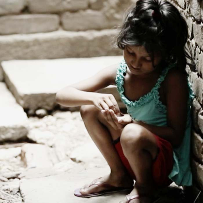 Sponsored girl washes her hands with water pump in Myanmar paid for with ActionAid child sponsorship