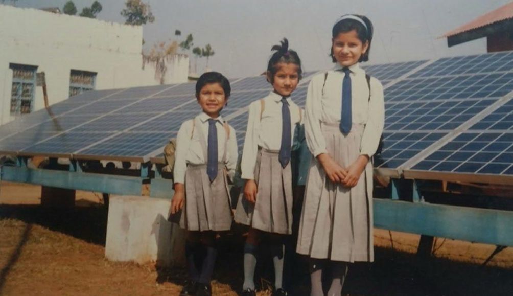 Ruby standing with her sisters posing for a photo after school in Nepal.