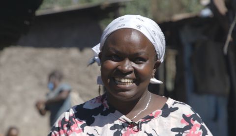 Wanja is delighted at the opening of a new water, sanitation and hygiene (WASH) facility in City Carton, Kenya. Africa Youth Trust/ActionAid