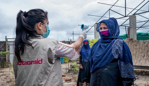 ActionAid worker Uthiya yea Marma is checking Anowara's body temperature before letting her enter inside ActionAid'ss women-friendly space. Cox's Bazar Rohingya Refugee Camp