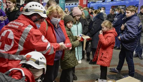 Ukrainian Red Cross staff providing food and basic necessities to people sheltering in a subway station in Kyiv, Ukraine