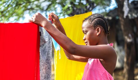 A young girl hanging up the washing