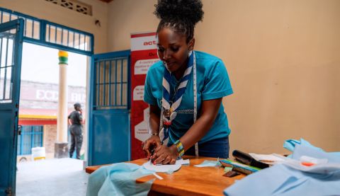 Woman cutting a piece of fabric 