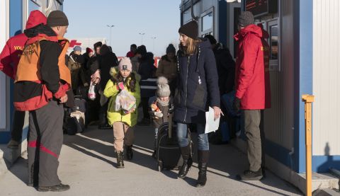 Families being ushered by officials as they escape war