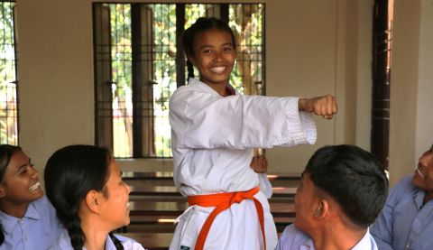 Girl in karate uniform at school