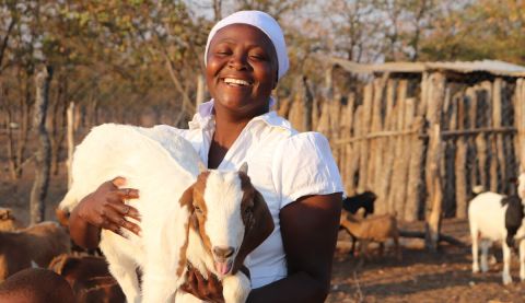 Woman holding a goat