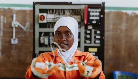Woman holding up a wire