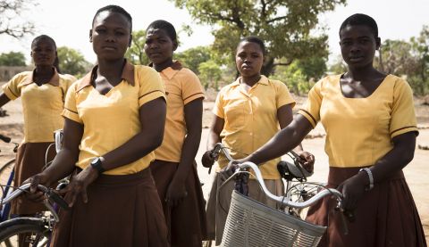 Theresa (left) and her friends were given bikes by ActionAid so they could travel to school safely in northern Ghana.