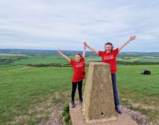 Woman and child celebrating with hands in the air