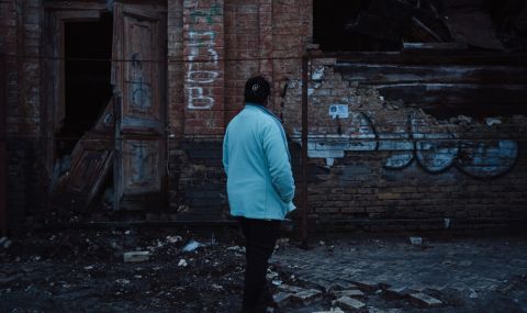 Liza (not her real name), an Insight volunteer, pictured outside a destroyed house in Kyiv