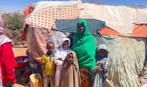 Suleekha, outside her her shop with her family. ActionAid.