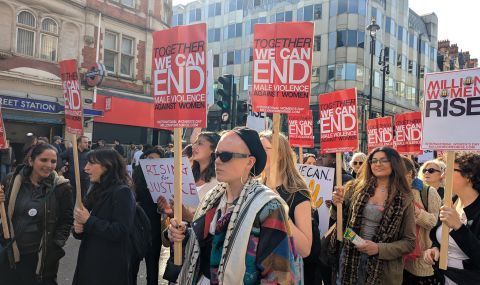 ActionAid at women's march holding placards