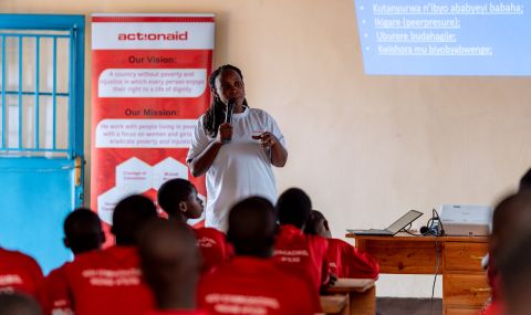 A woman giving a talk to classroom of girls