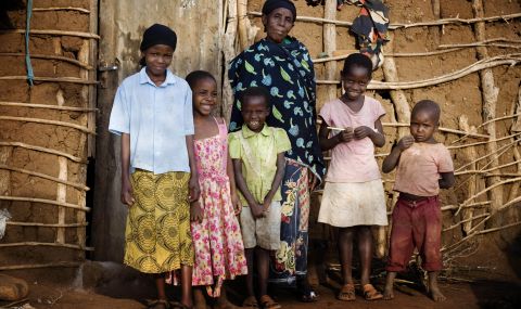Maua Juma (left), 11 with her mother and siblings outside their house. Maua Juma is going to school thanks to an education project in her community, supported by ActionAid