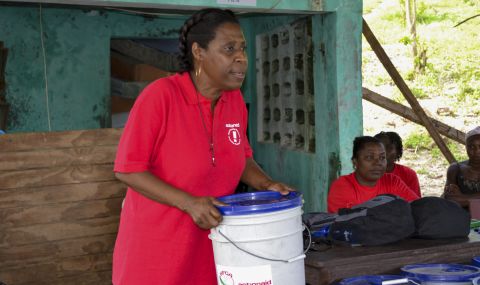 Marie-Andree of ActionAid Haiti distributes emergency kits in the aftermath of Hurricane Matthew.