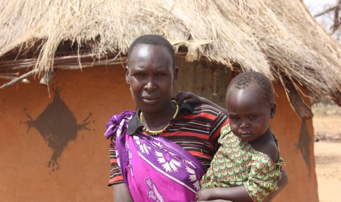 Chepochemuna Raphael holds her daughter. She is fearful about the lack of food in her community.