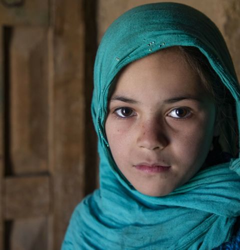 Haidah* (Laila's daughter) poses for a photograph in the family home in Afghanistan.