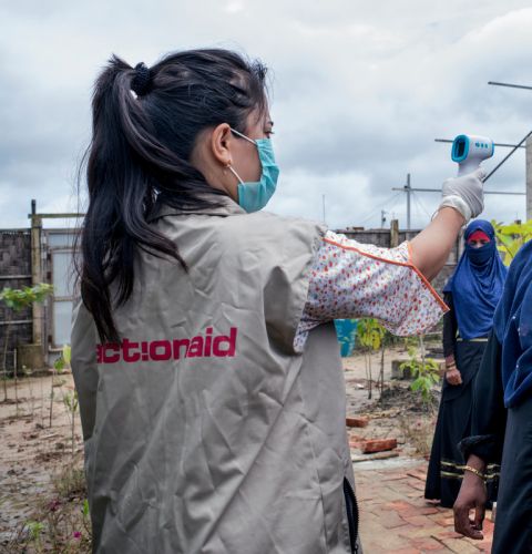 ActionAid worker Uthiya yea Marma is checking Anowara's body temperature before letting her enter inside ActionAid'ss women-friendly space. Cox's Bazar Rohingya Refugee Camp