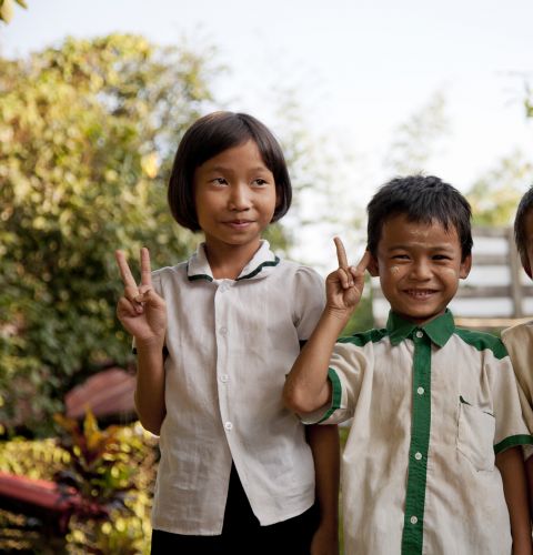 Poe Nay Min, Kali say, Nay Blute Moo (right to left) in front of school after their classes.