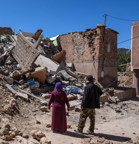 A brother and sister search the remains of the sister's home following the deadly earthquake on September 10, 2023 in Moulay Brahim, Morocco.