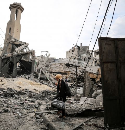 Palestinians inspect a mosque destroyed in strikes on one of Gaza City's refugee camps.