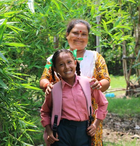 A mother and a child smiling at the camera