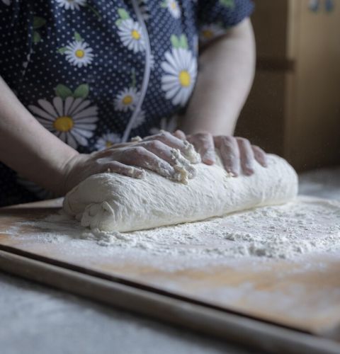 A woman kneading dough
