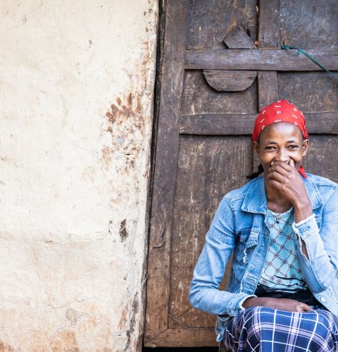 A woman covering her smile with her hand