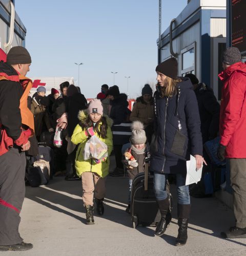 Families being ushered by officials as they escape war