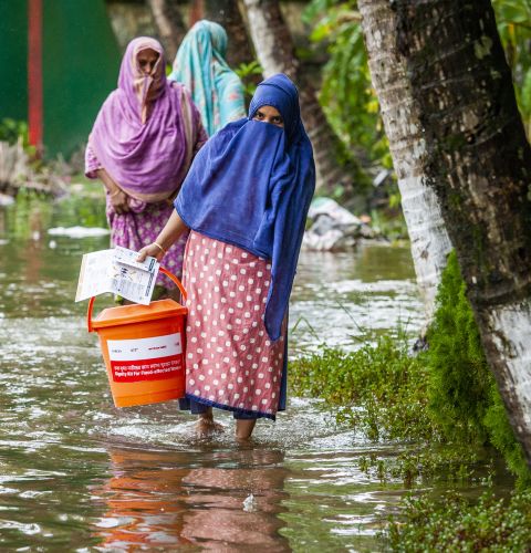 Women carrying supplies during the floods in Bangladesh