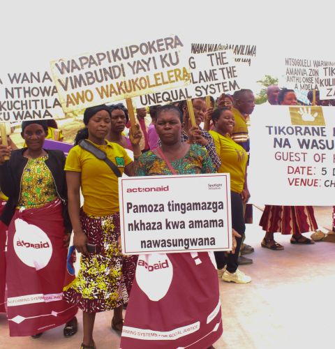 women at a march holding signs