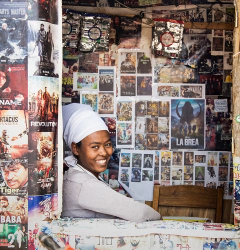 Woman looking out from a shop