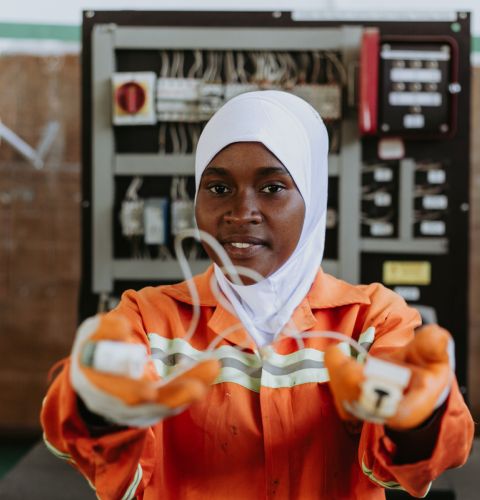 Woman holding up a wire