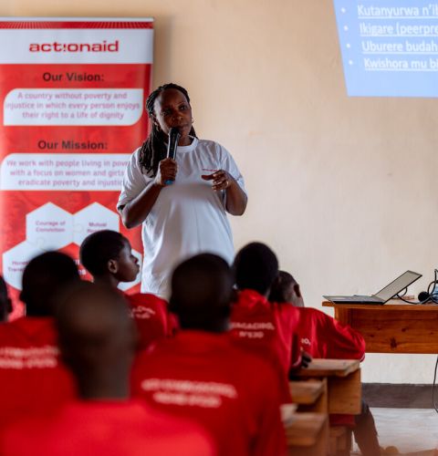A woman giving a talk to classroom of girls