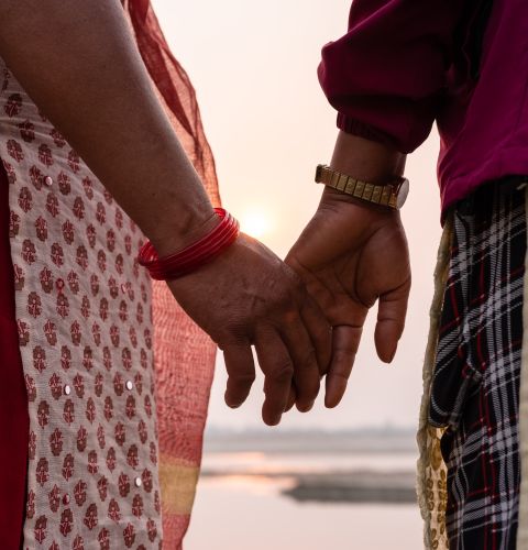 Holding hands by the river