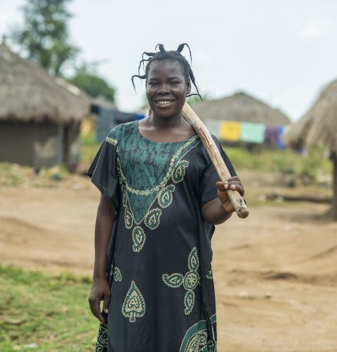 Woman holding a stick over her shoulder