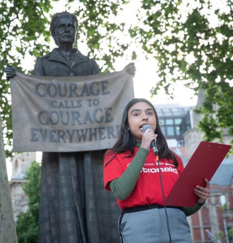 Community Campaigner speaking at podium