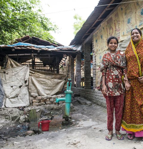 woman and daughter outside their house