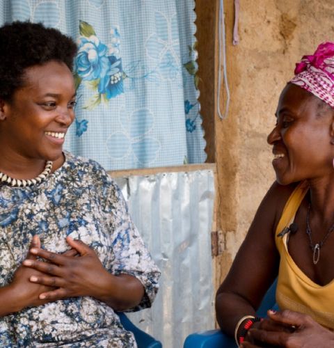 Celebrity Wunmi speaking to a woman and smiling.