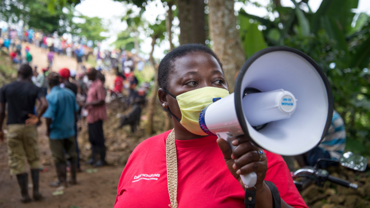 Lucina, in the largest marketplace in the region of Jacmel, Cap Rouge in Haiti promoting safe hygiene practices during the Covid-19 sanitary health alert.