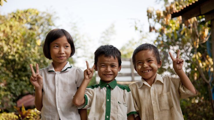 Poe Nay Min, Kali say, Nay Blute Moo (right to left) in front of school after their classes.