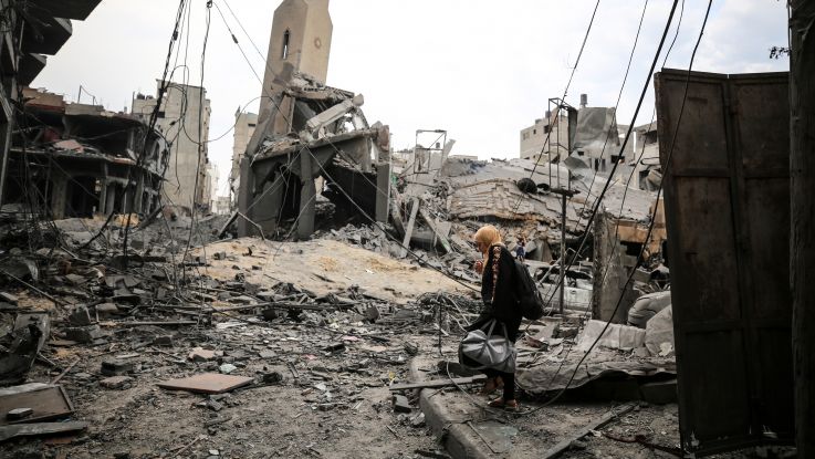 Palestinians inspect a mosque destroyed in strikes on one of Gaza City's refugee camps.