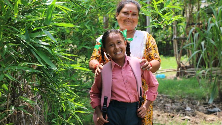A mother and a child smiling at the camera