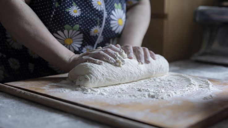 A woman kneading dough