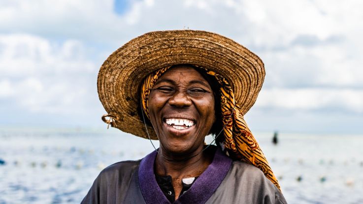 A seaweed farmer smiling to camera