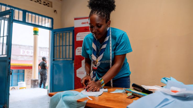 Woman cutting a piece of fabric 