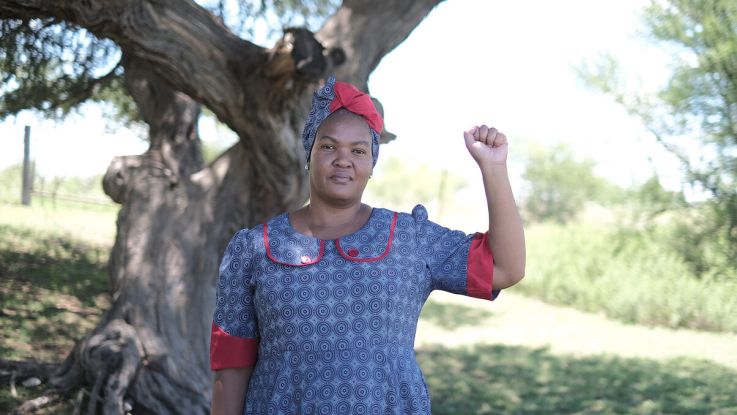 Woman holding up a fist in defiance