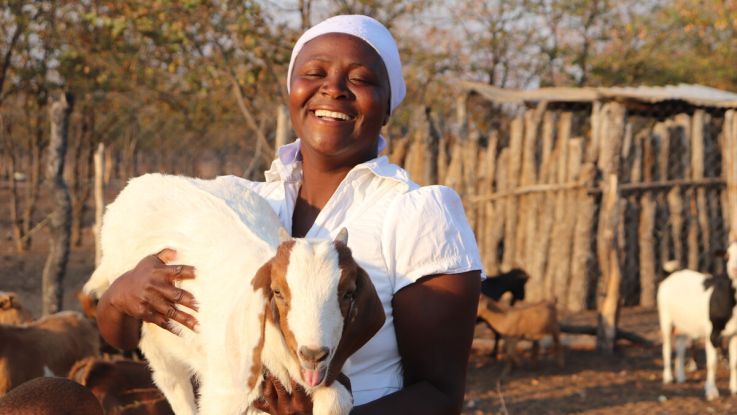 Woman holding a goat