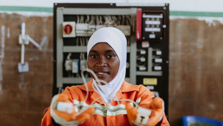 Woman holding up a wire