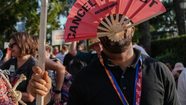 People protesting and demanding urgent debt cancellation